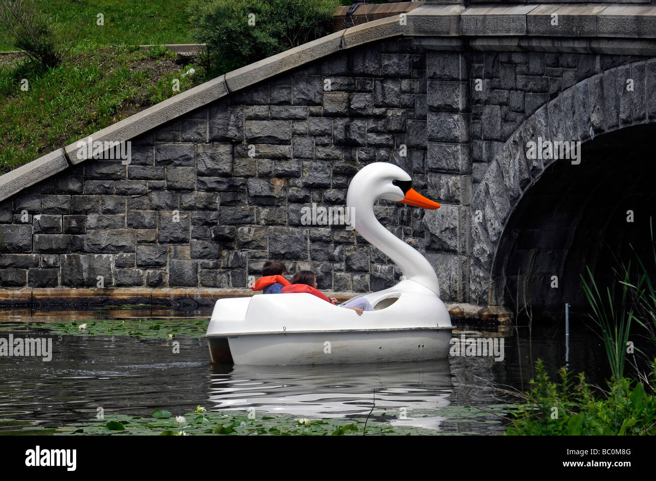 Young boy and girl in paddle boat in  park Stock Photo