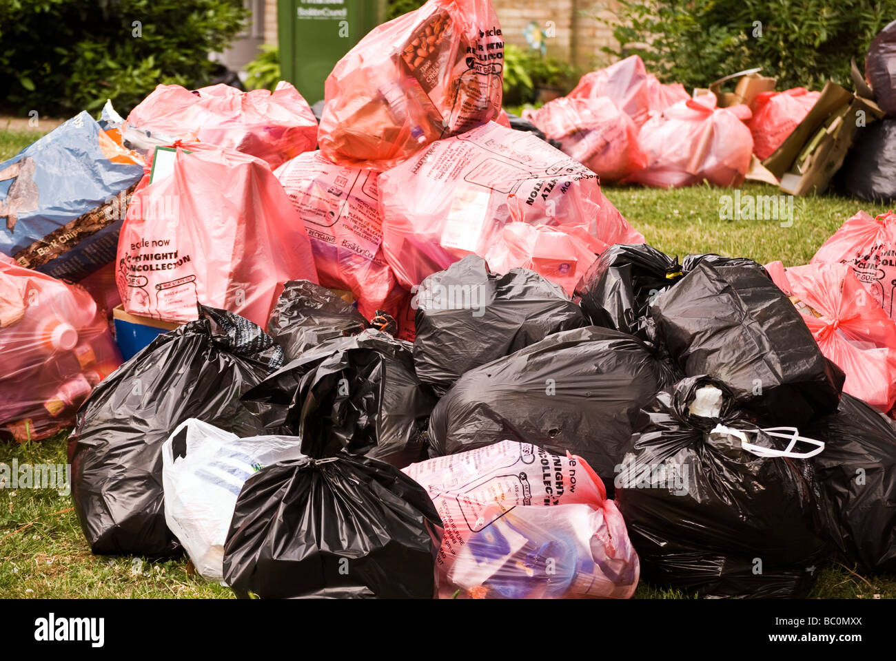 red and black bin bags awaiting collection Stock Photo