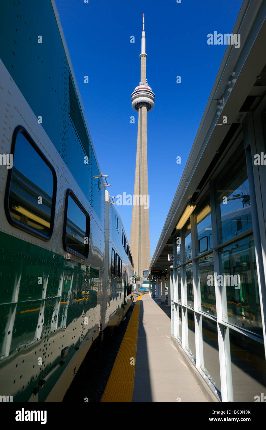 CN Tower between GO train and Union Station Toronto with blue sky in the morning Stock Photo