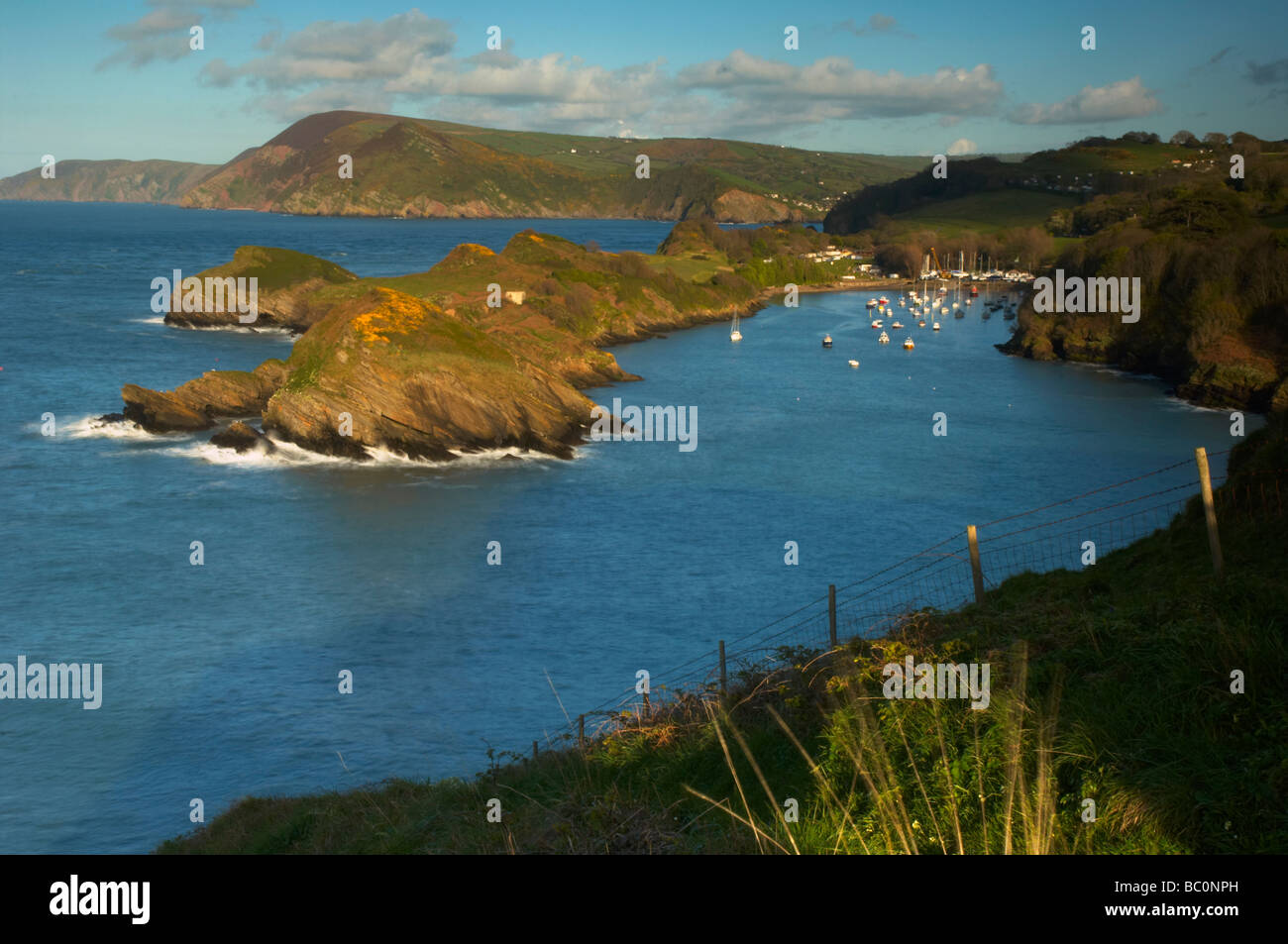 Luxury Yachts Moored In The Picturesque Watermouth Bay Harbour With luxury-yachts-moored-in-the-picturesque-watermouth-bay-harbour-with