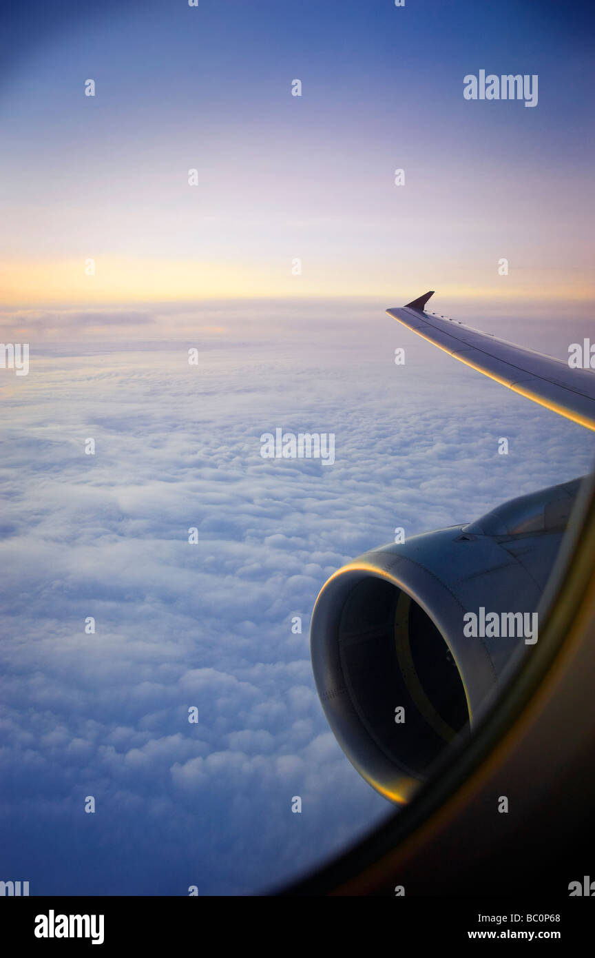 Jet Engine And Wing During Flight At Sunset Stock Photo