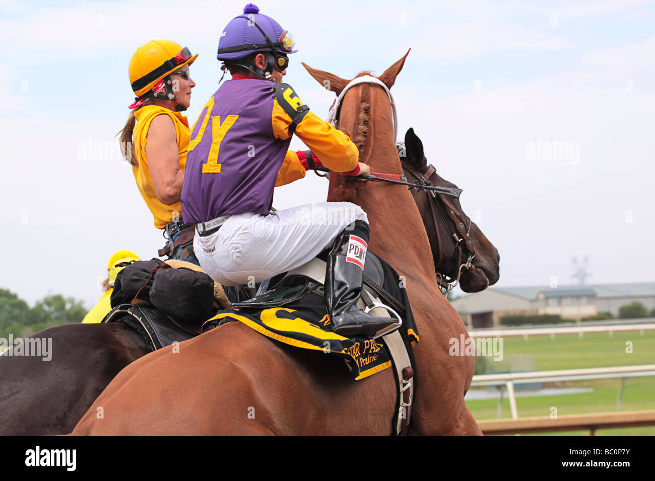 Jockey riding along Trainer. Stock Photo