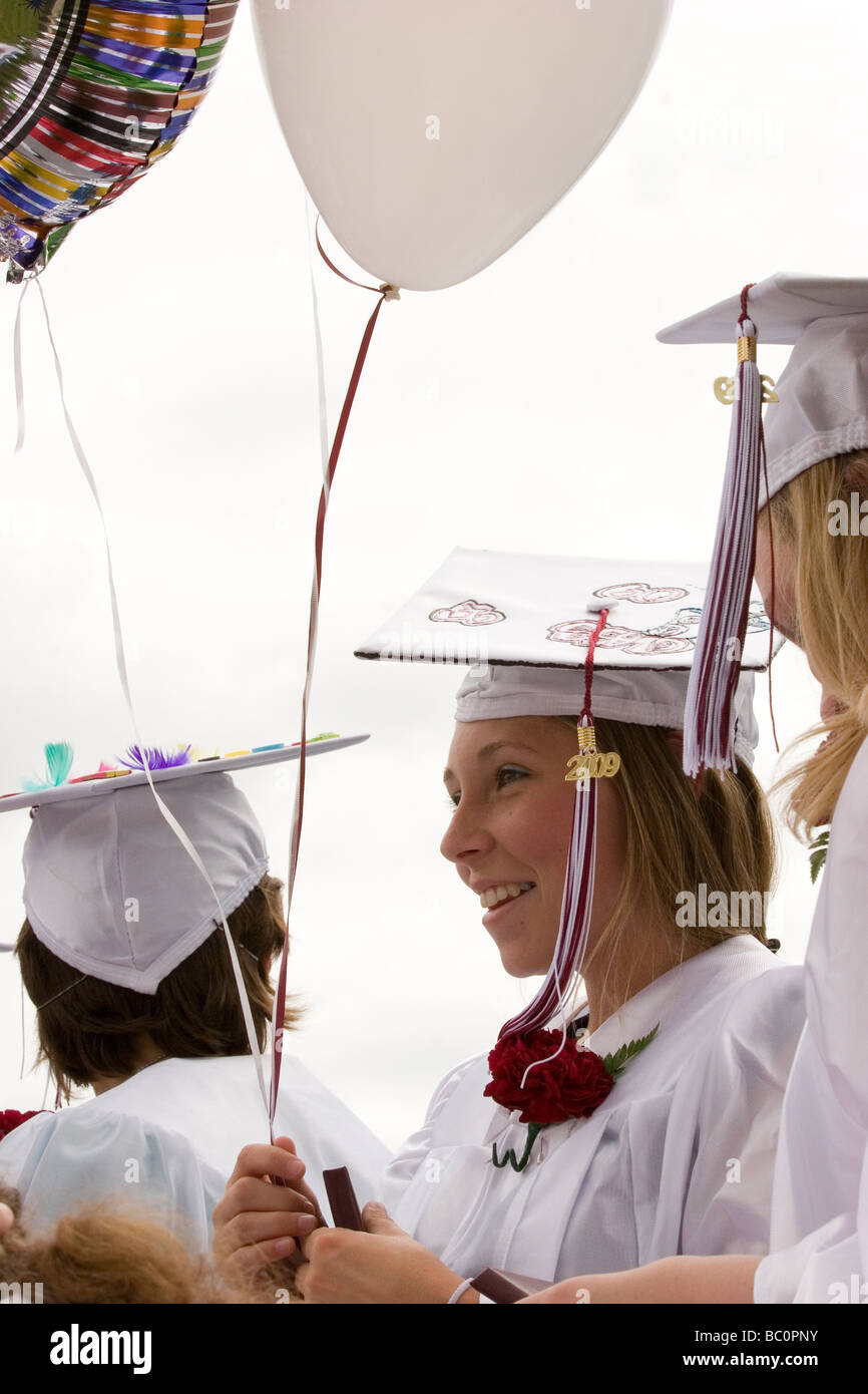 Graduation ceremony, female high school student in cap and gown Stock