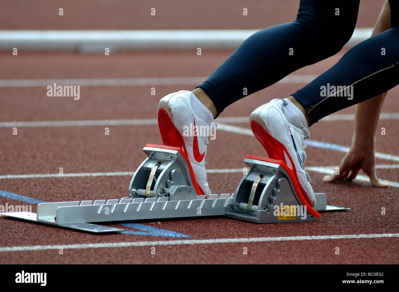 Runner in starting blocks Stock Photo Alamy