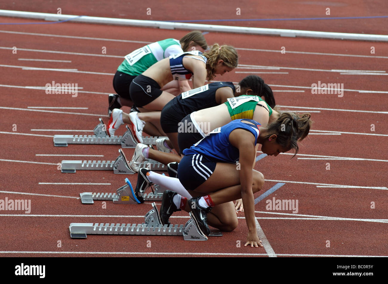 Female athletes in starting blocks hires stock photography and images