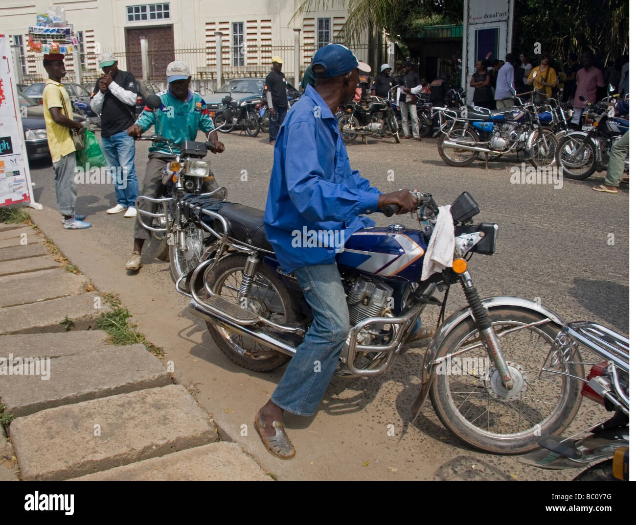 Motorcycle taxi drivers Douala Cameroon West Africa Known as Bendskins or motos Stock Photo