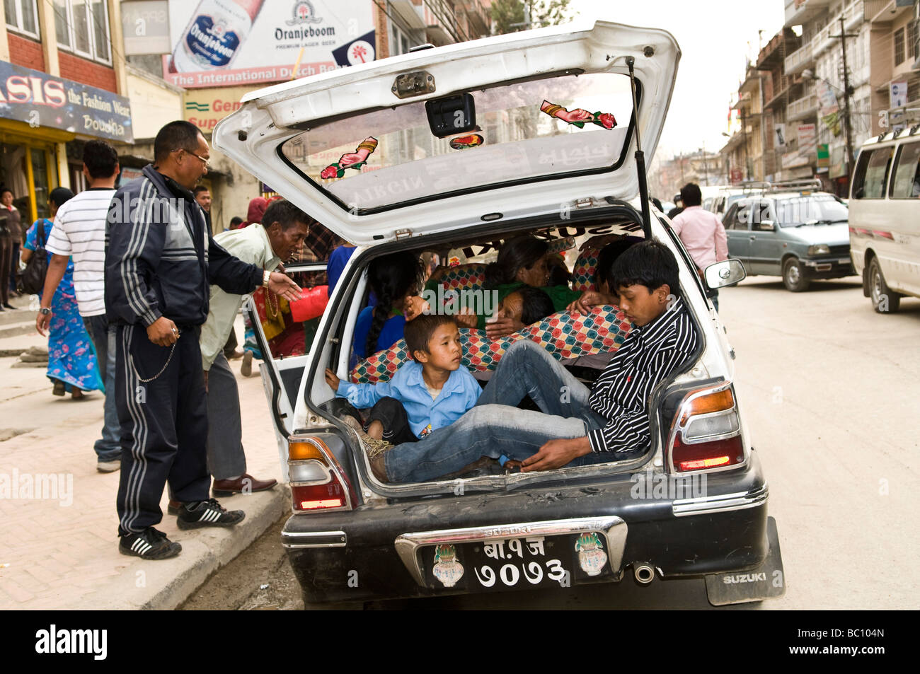 A small Maruti Suzuki car with more than 10 people inside Stock Photo