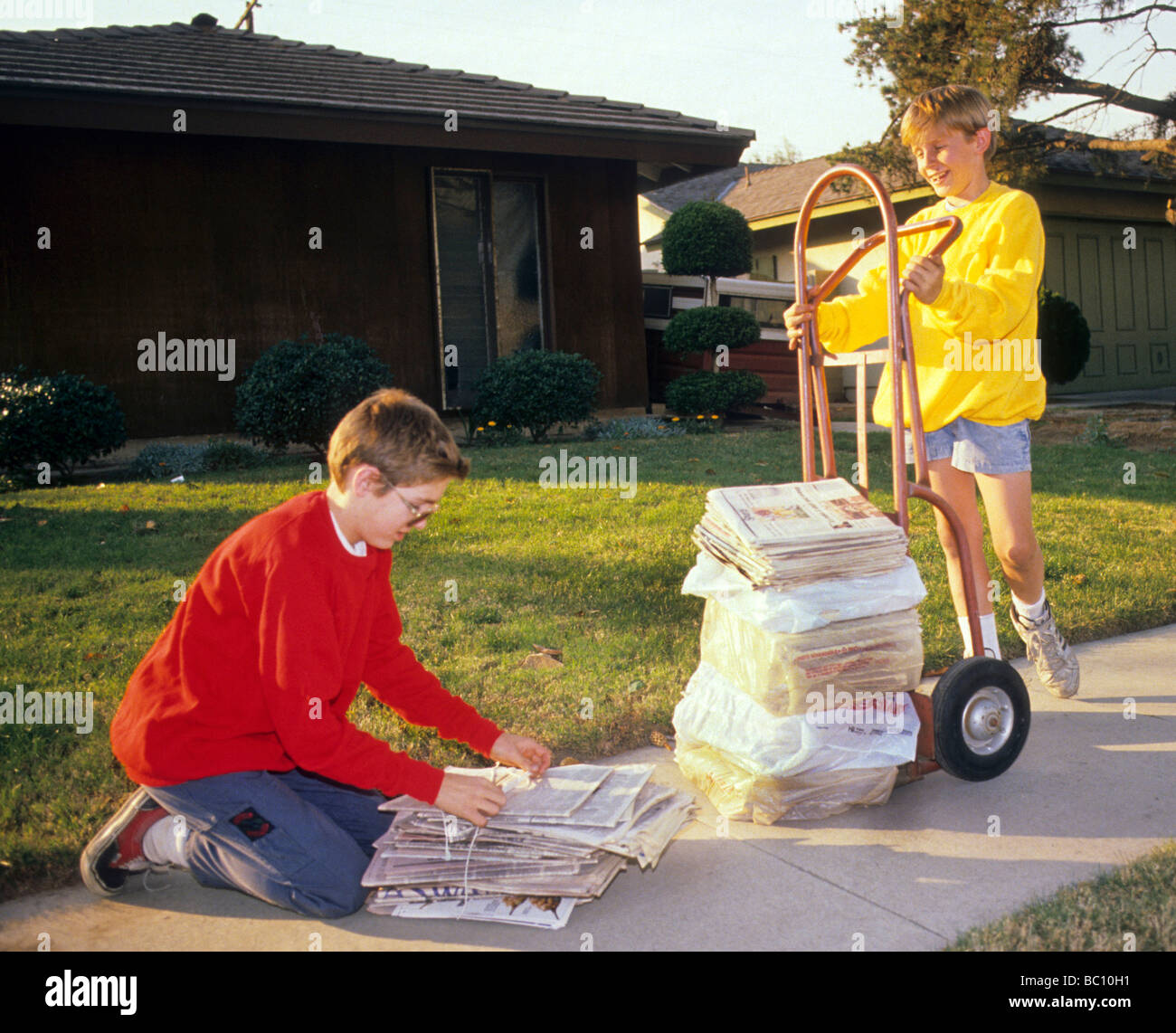boy recycle newspaper waste environment save ecology dolly tie Stock