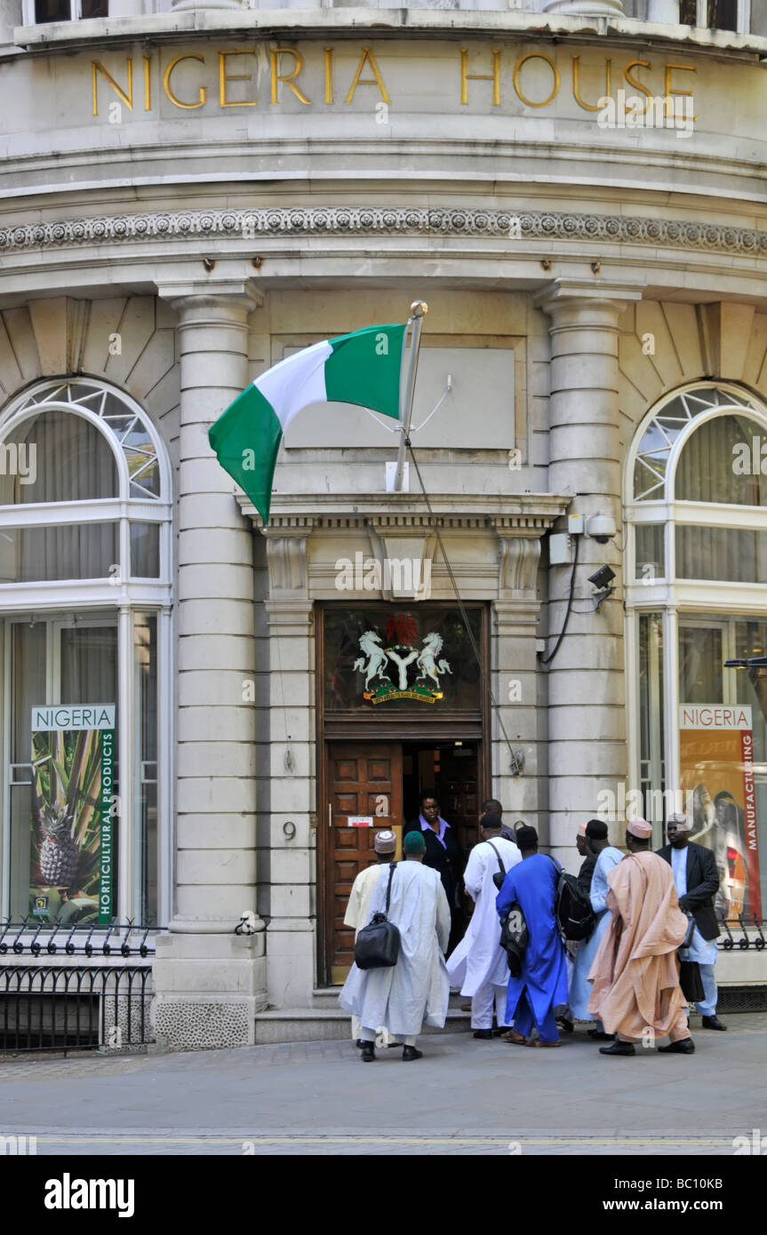 Street scene at The Nigeria High Commission in Nigeria House with National flag flying and entrance doors being opened to visitors London England UK Stock Photo