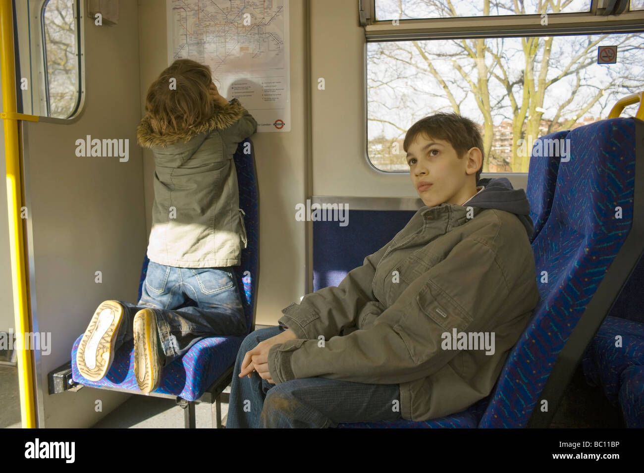 Two boys on a train journey in North London Stock Photo Alamy
