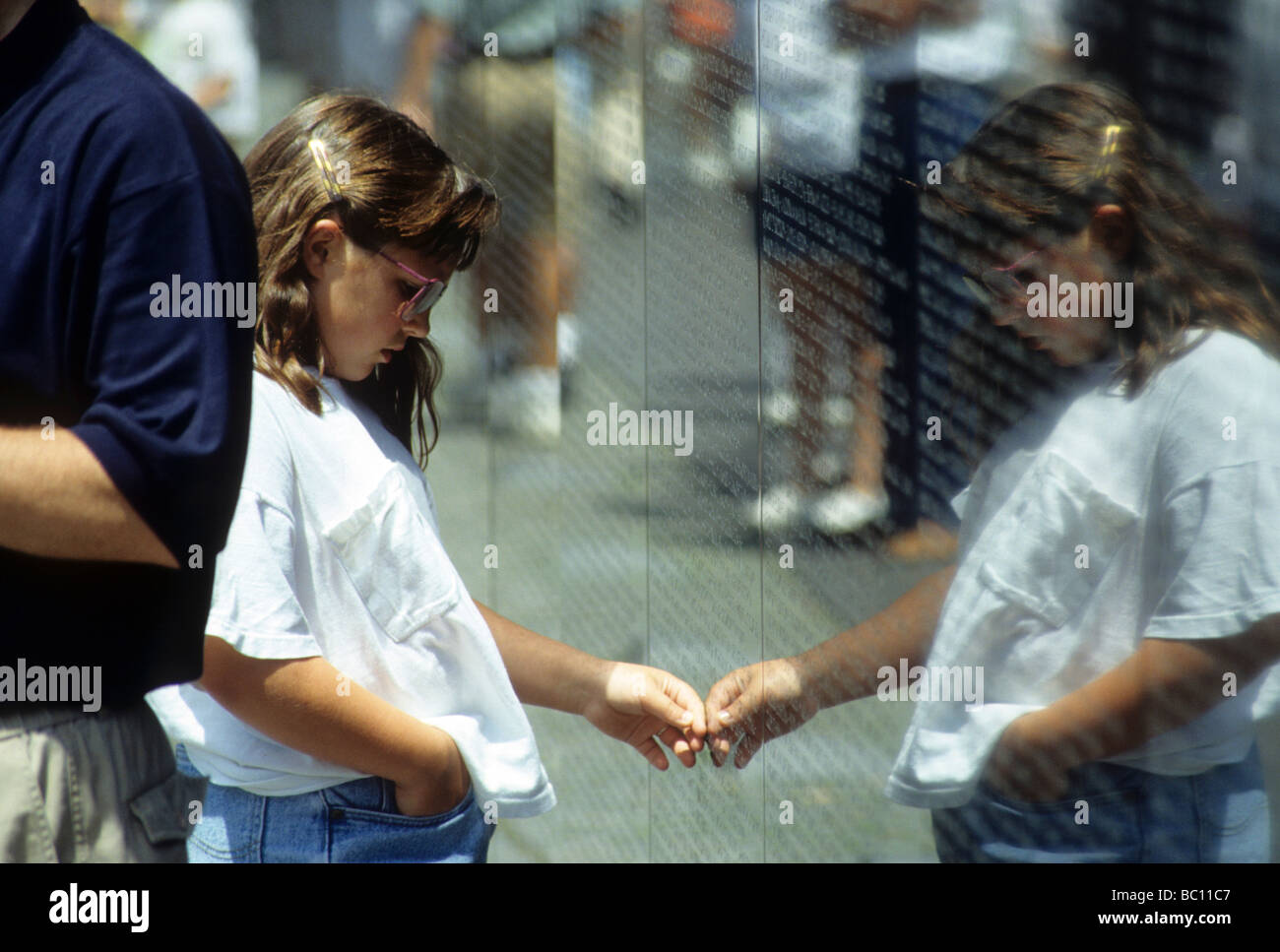 vietnam wall washington dc memory memorial vet military army soldier marine air force navy history rub name girl sad touch Stock Photo