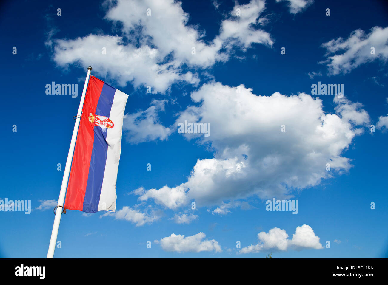 Flag of Serbia under the clouds Stock Photo