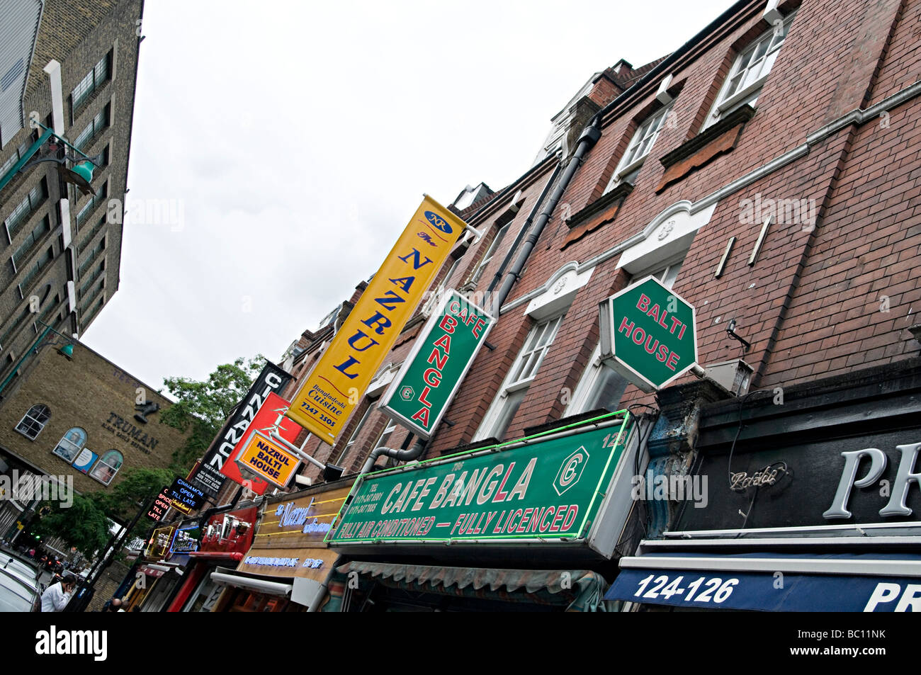 famous curry restaurant signs down brick lane in the east end of london