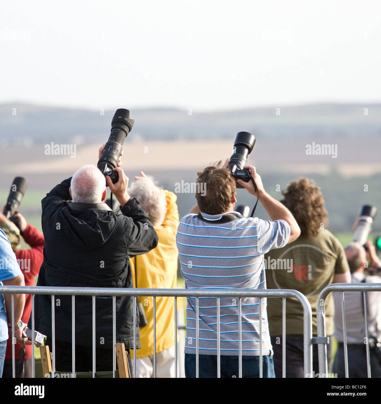 Photographers flowing planes at an airshow. Stock Photo