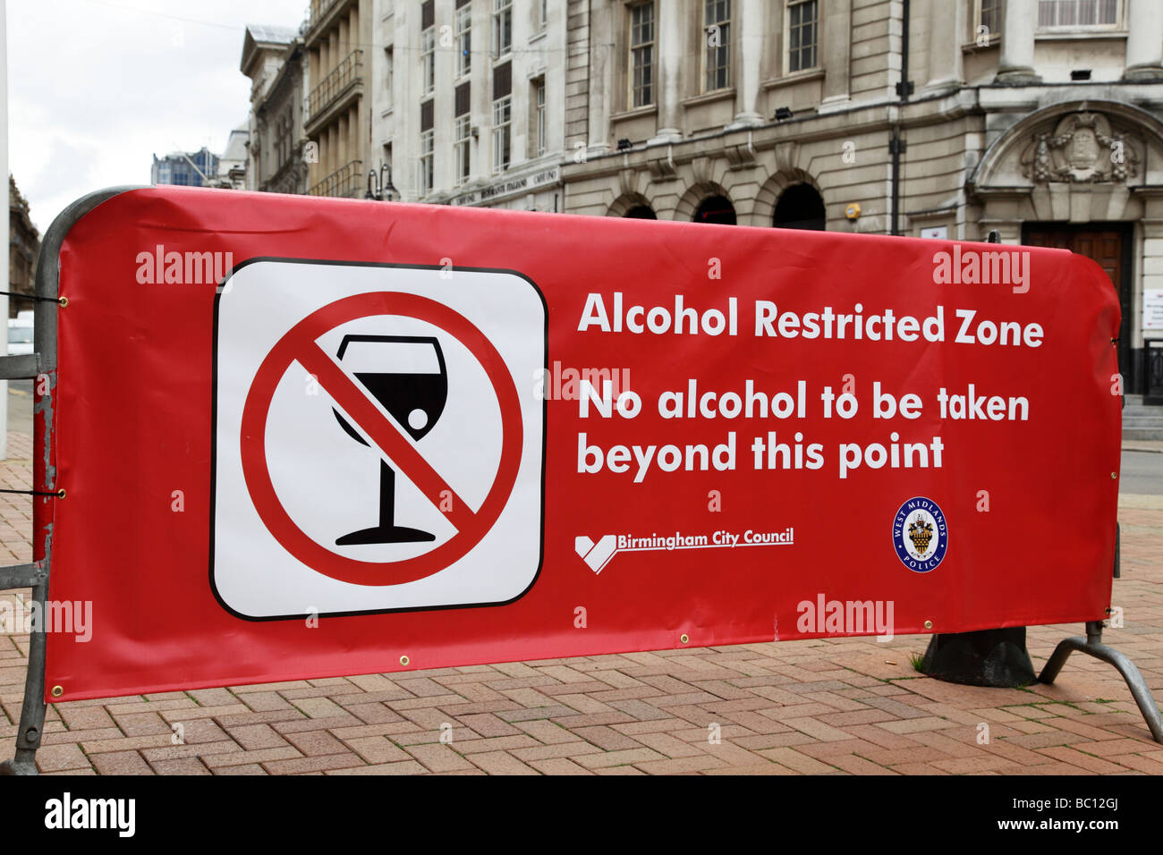 alcohol restricted zone banner stopping people from taking drinks from outside victoria square birmingham uk Stock Photo
