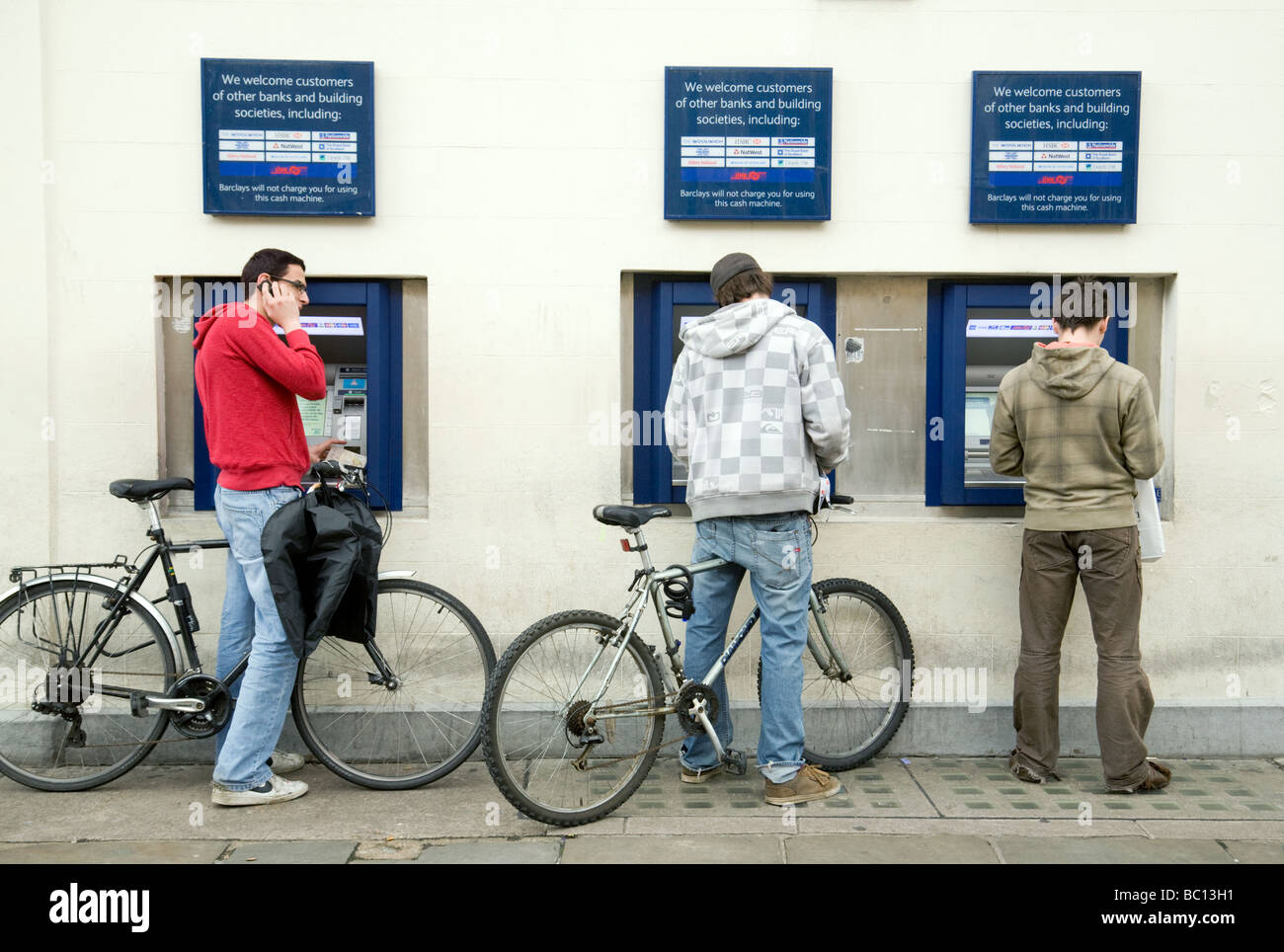 University students using the three Barclays bank ATMs, Market Square, Cambridge, UK Stock Photo