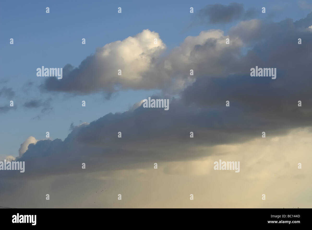 Dark clouds in the sunset blue sky Stock Photo - Alamy