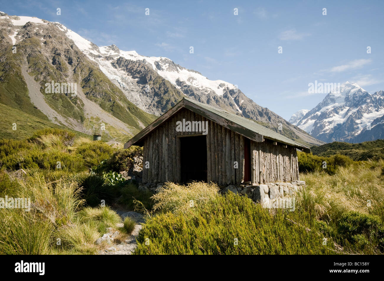 Stocking Stream hikers shelter in the Hooker Valley - Mt Cook visible in the background Stock Photo