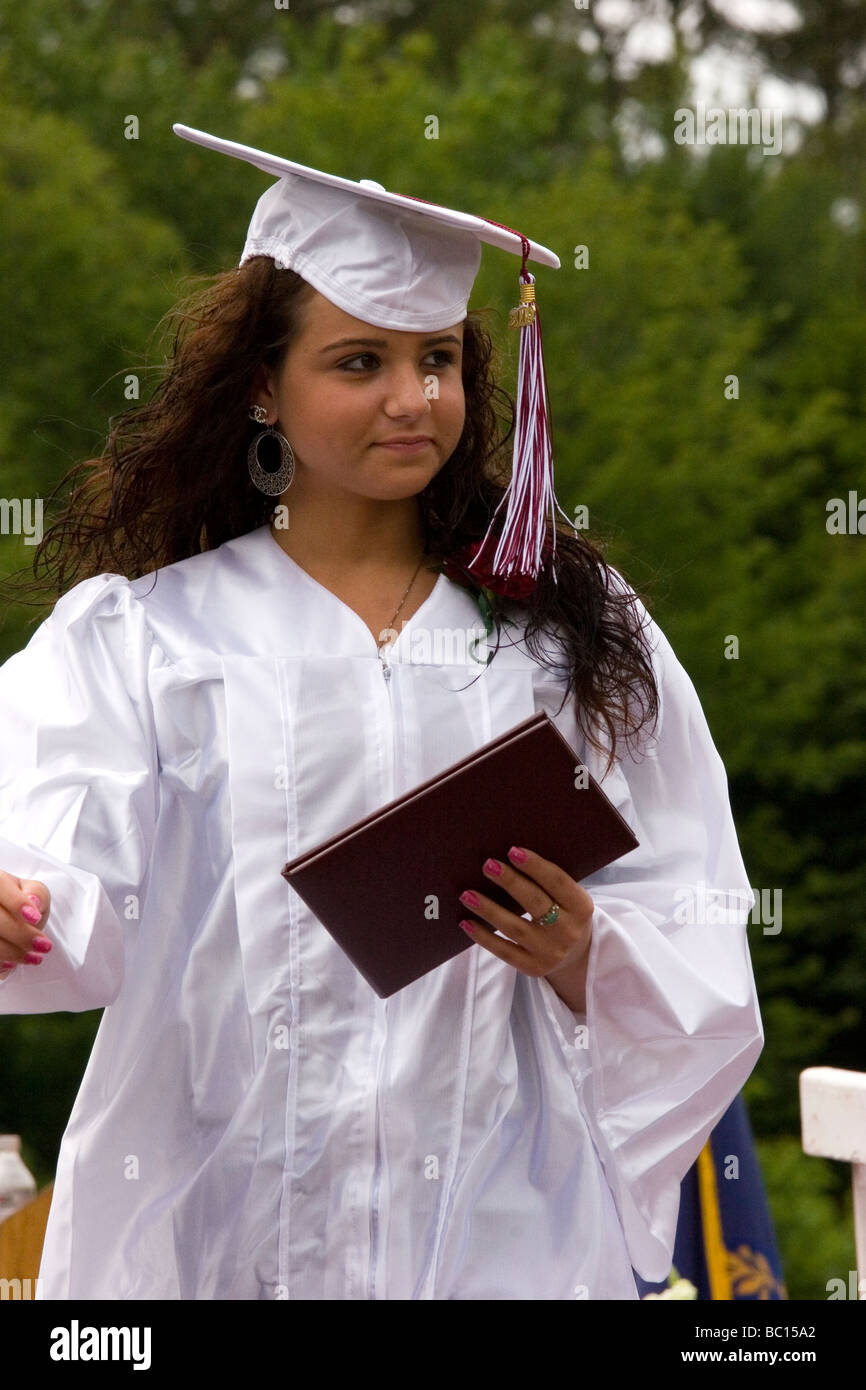 Graduation ceremony, high school student in cap and gown with diploma Stock Photo