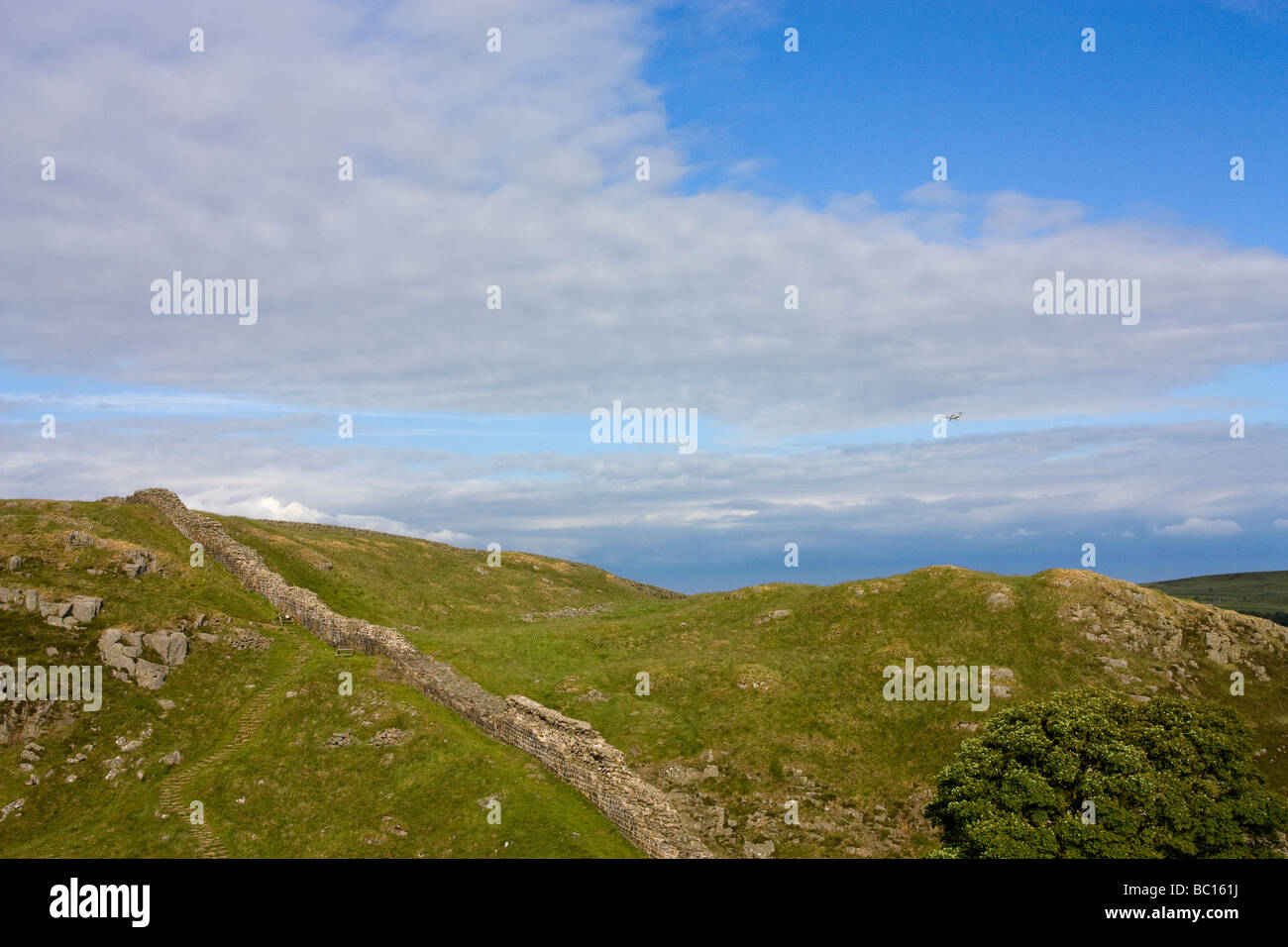 Light aircraft flying above steel rigg on Hadrians wall, Northumberland ...