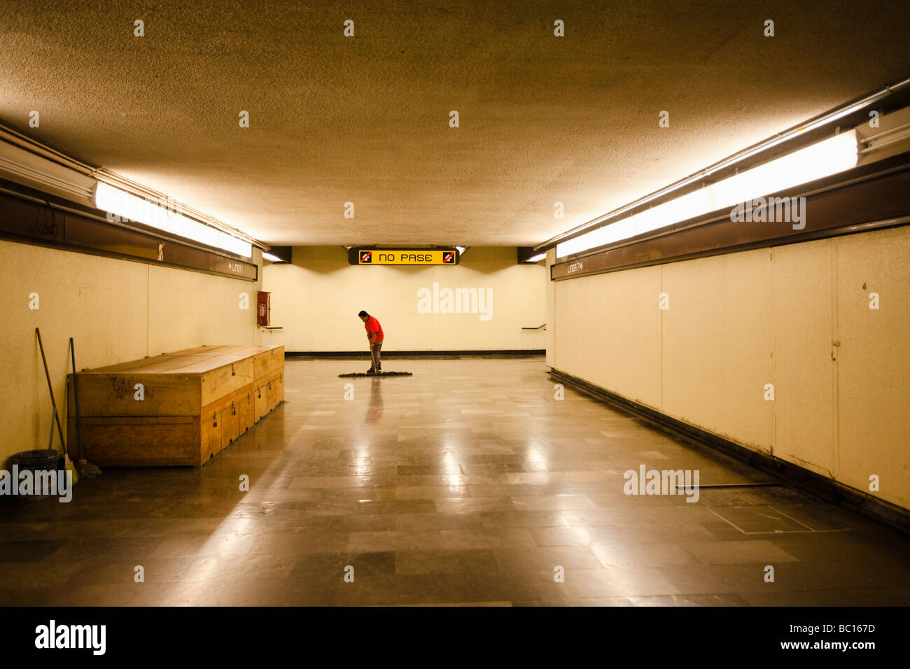 A worker cleans the floor in an empty metro (subway) station during the swine flu epidemic in Mexico City, DF, Mexico. Stock Photo