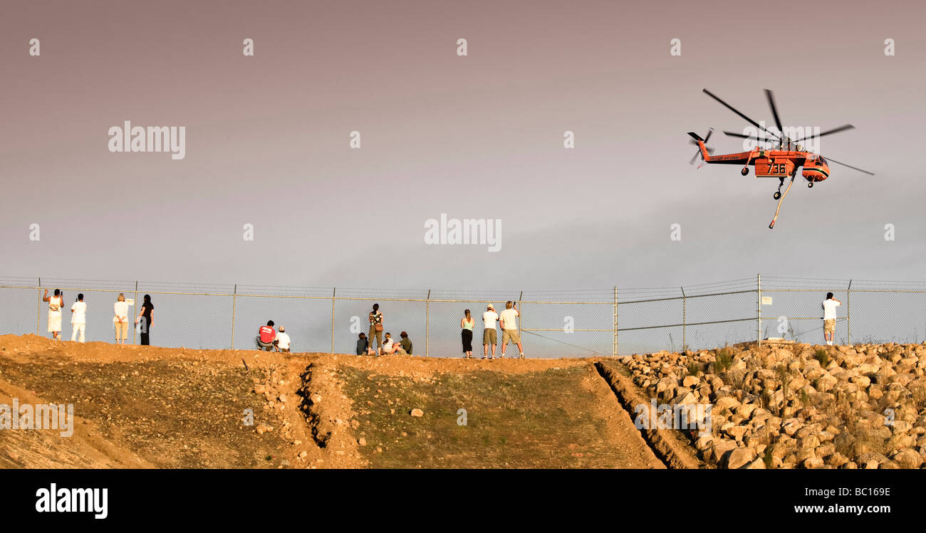 Helicopters pick up water from a reservoir while fighting wildfires in California Stock Photo