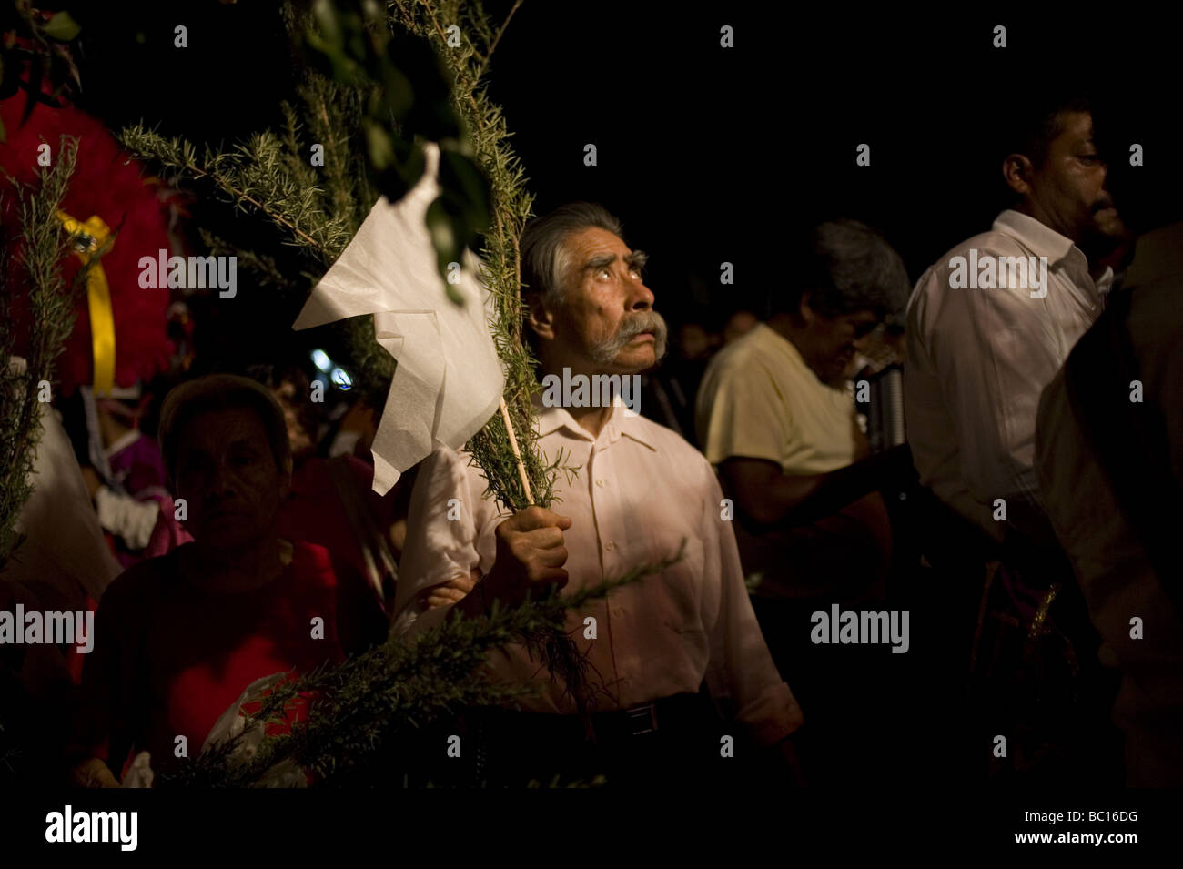 A man looks up at a statue of the resurrected Christ, unseen, during a holy week procession. Stock Photo