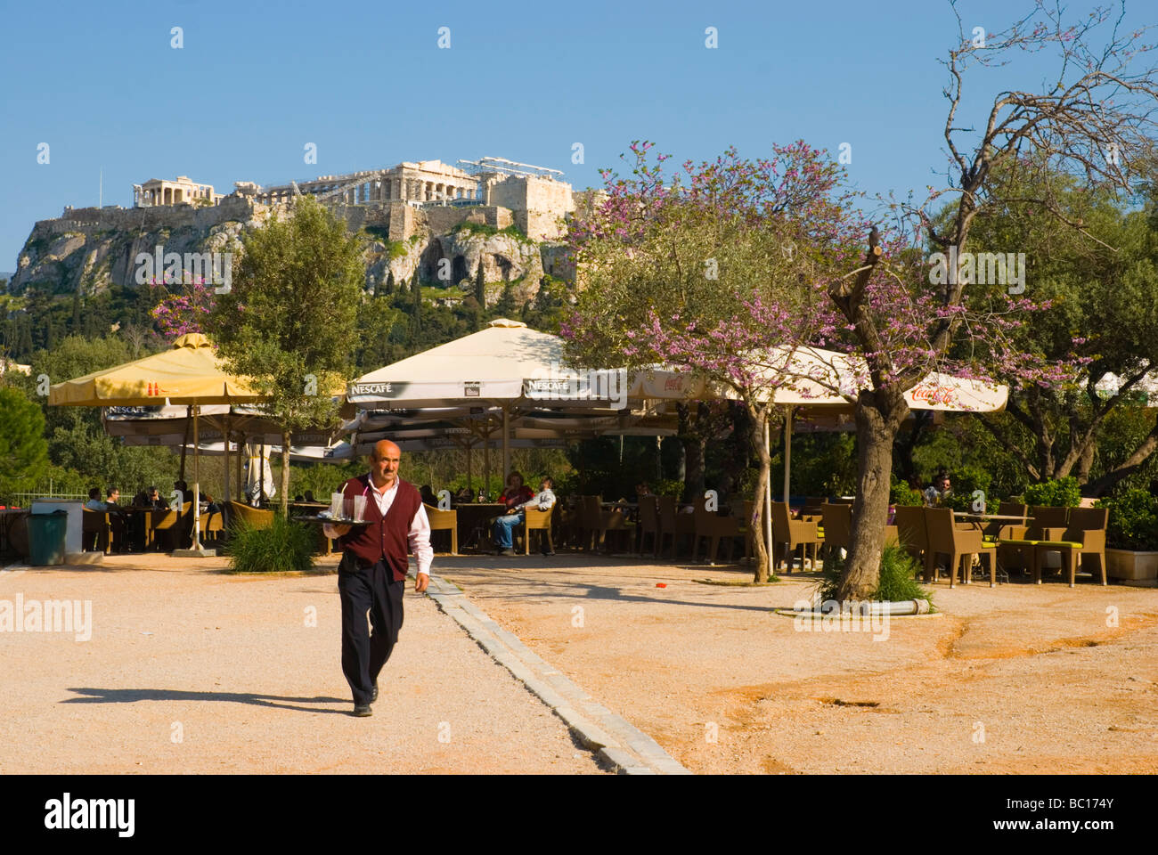 Cafe terraces below Acropolis in Plaka district of Athens Greece Europe Stock Photo