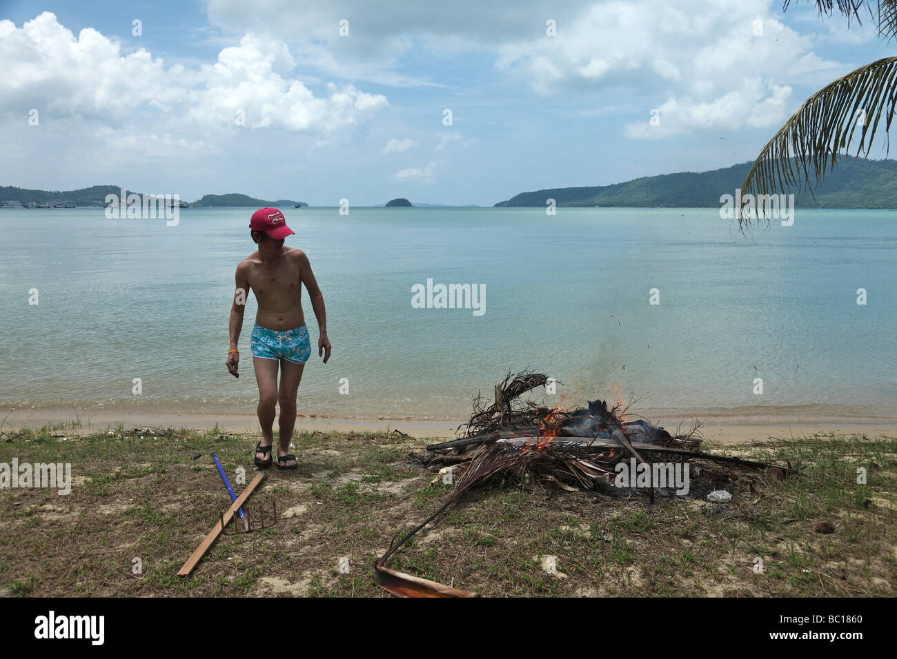 Lighting a fire on the beach in Phuket Stock Photo Alamy