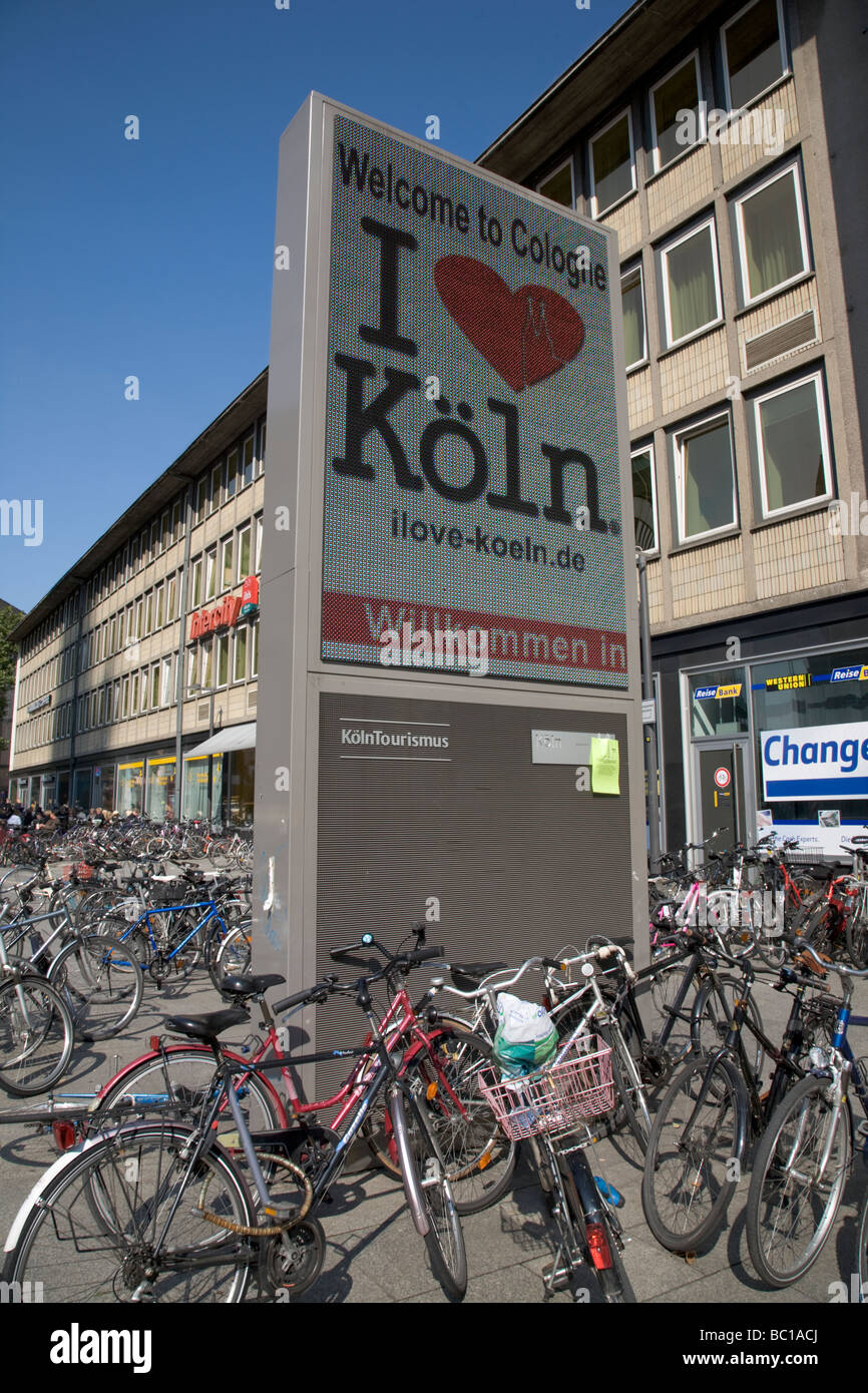 Bicycles Parked In Front Of Large Poster Promoting I Love Cologne Germany Stock Photo