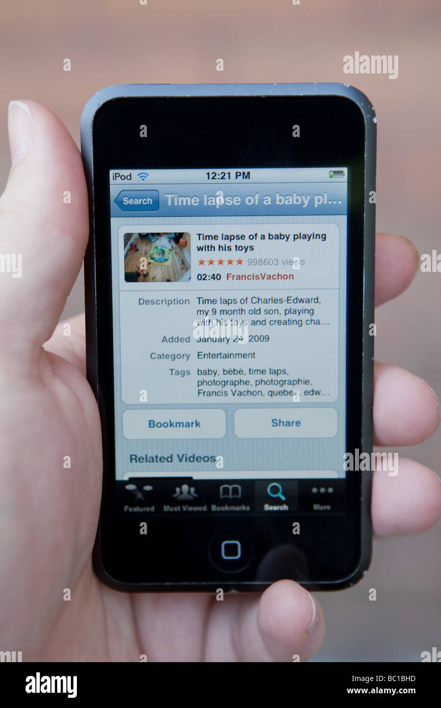 A Man Uses The Youtube Application To Watch A Video On An Apple Ipod Touch Stock Photo Alamy