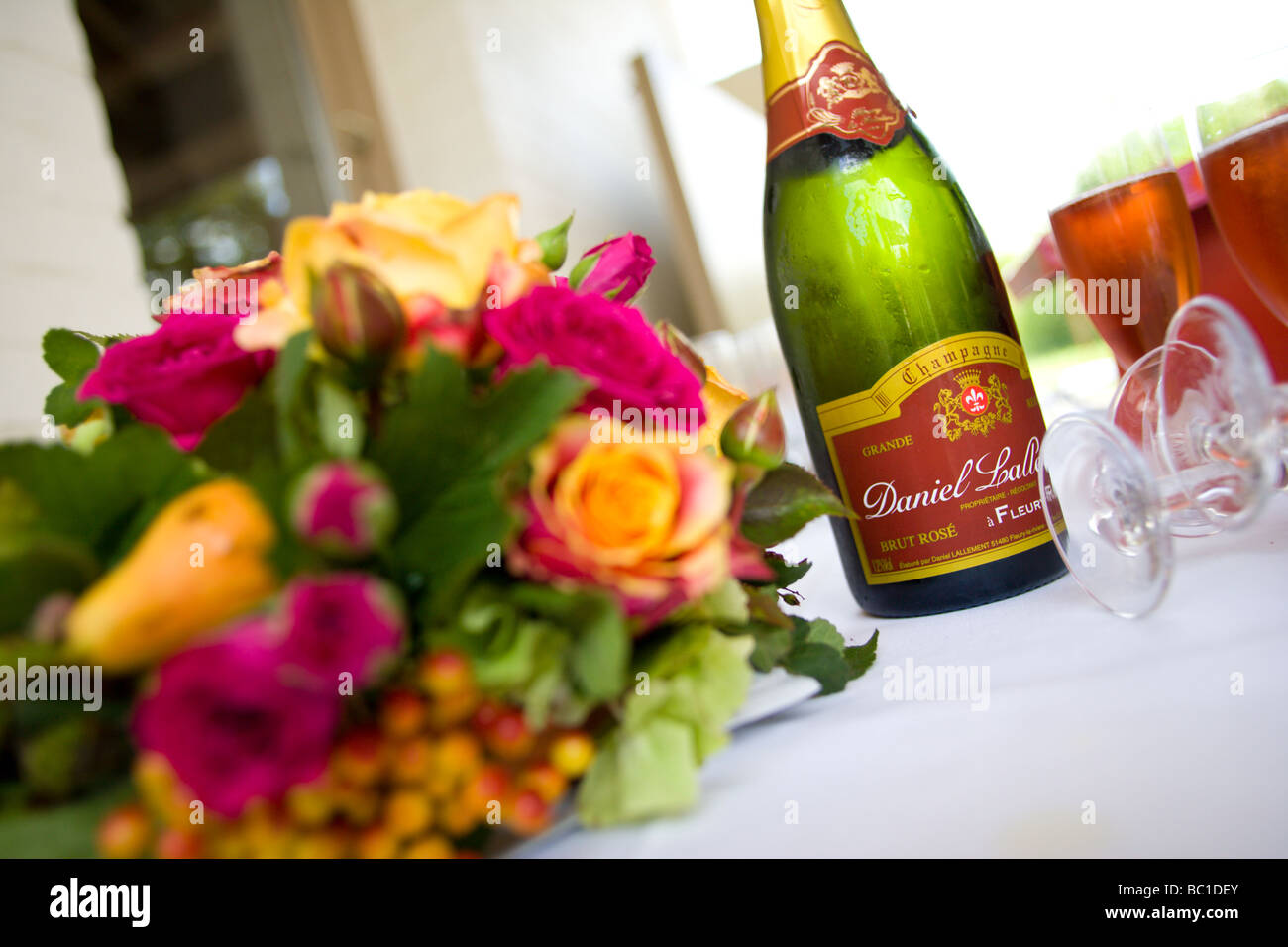A wedding celebration showing a champagne bottle, champagne glasses