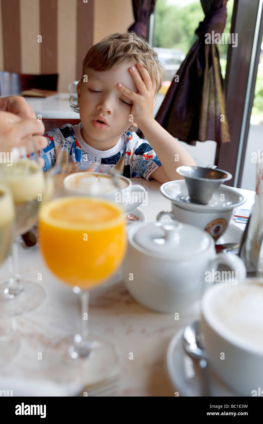 satisfied small boy breakfast in cafe Stock Photo