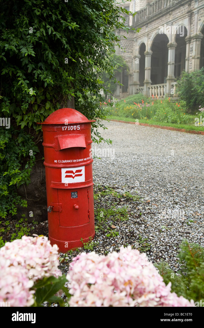 Red post box in the grounds of Viceregal Lodge, Shimla. Himachal Pradesh. India. Stock Photo