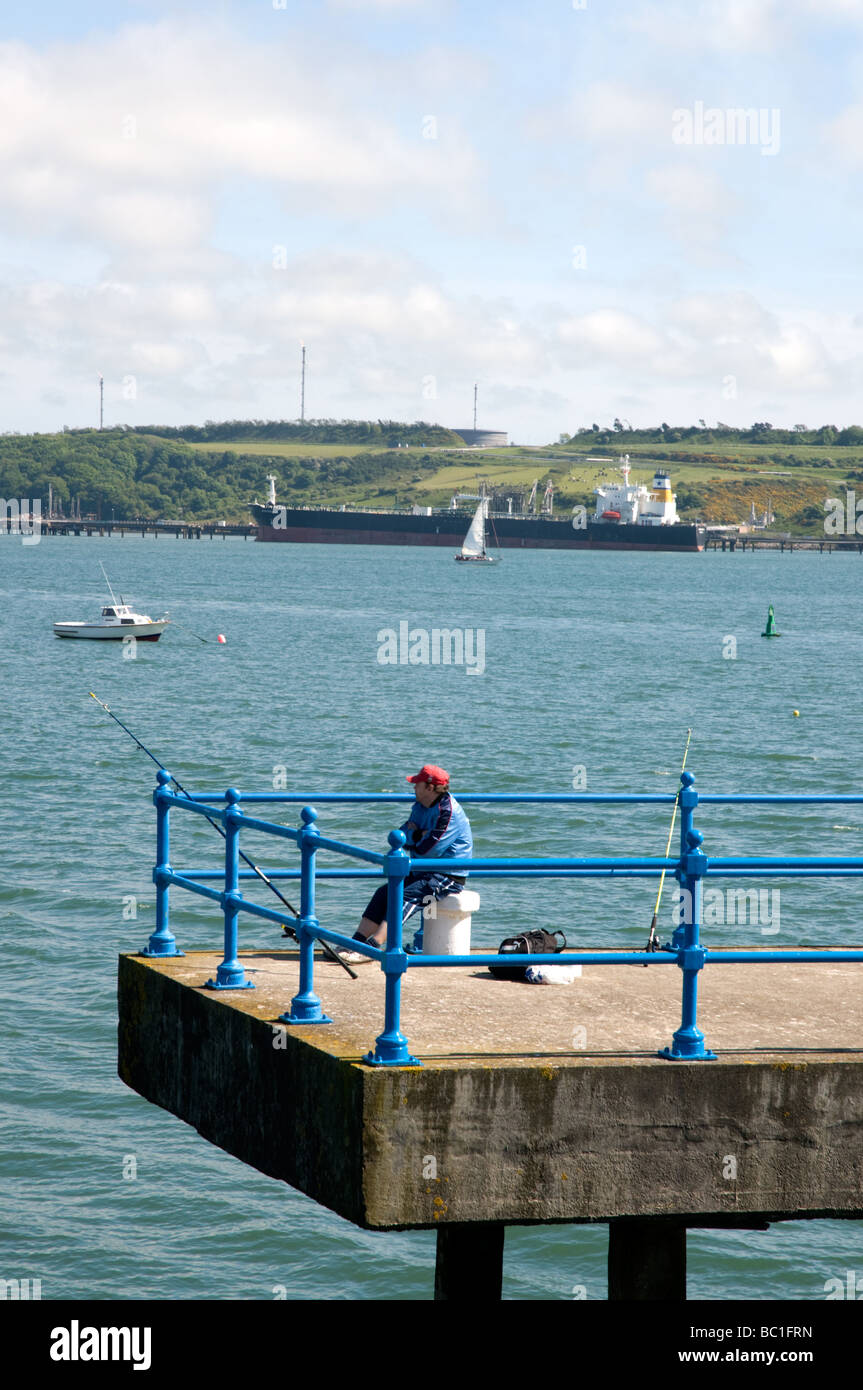 Man fishing on a peir at Milford haven in Pembrokeshire Stock Photo Alamy