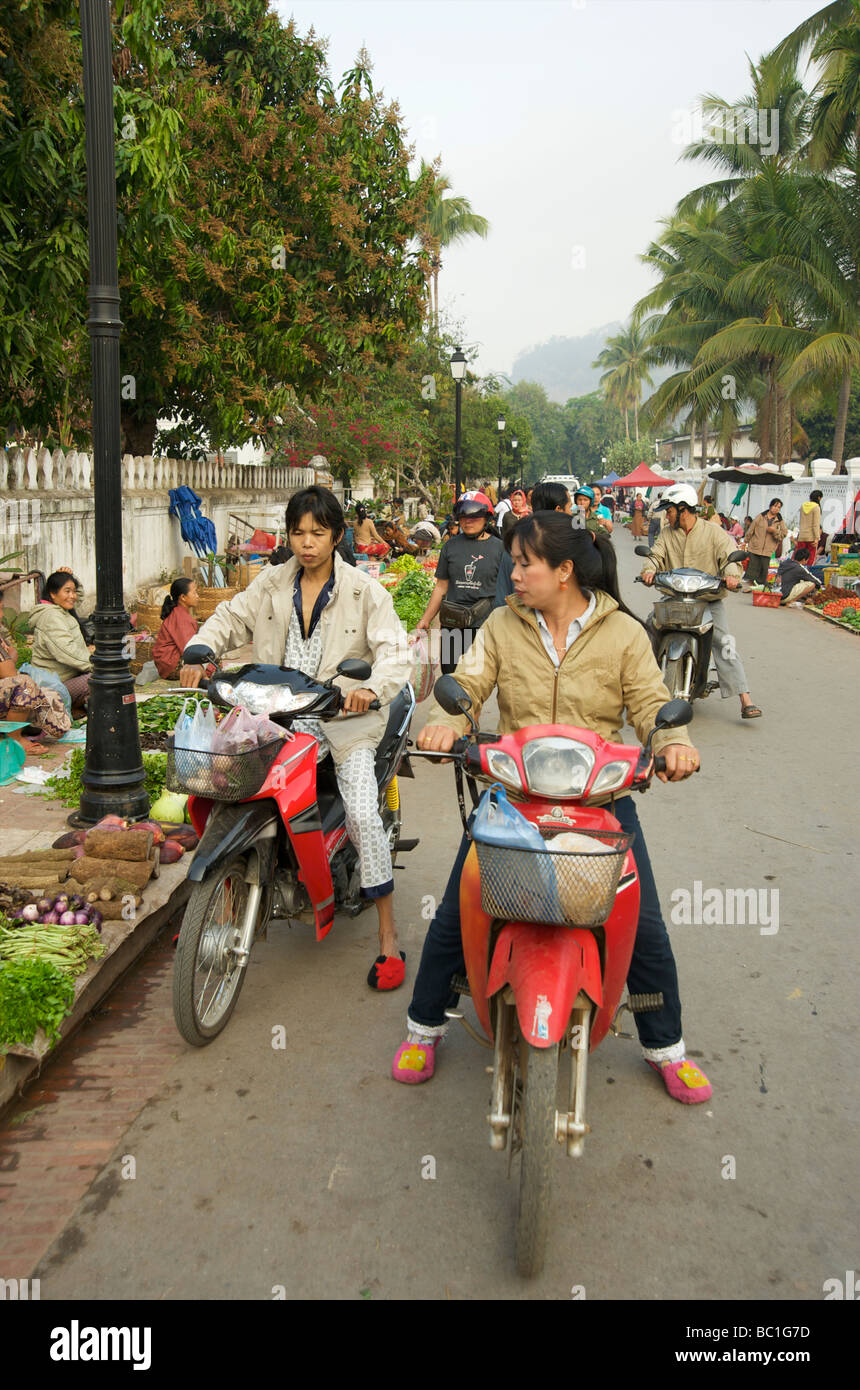 Fresh Food Shopping in the Old Royal Lao capital of Luang Prabang on mopeds Stock Photo
