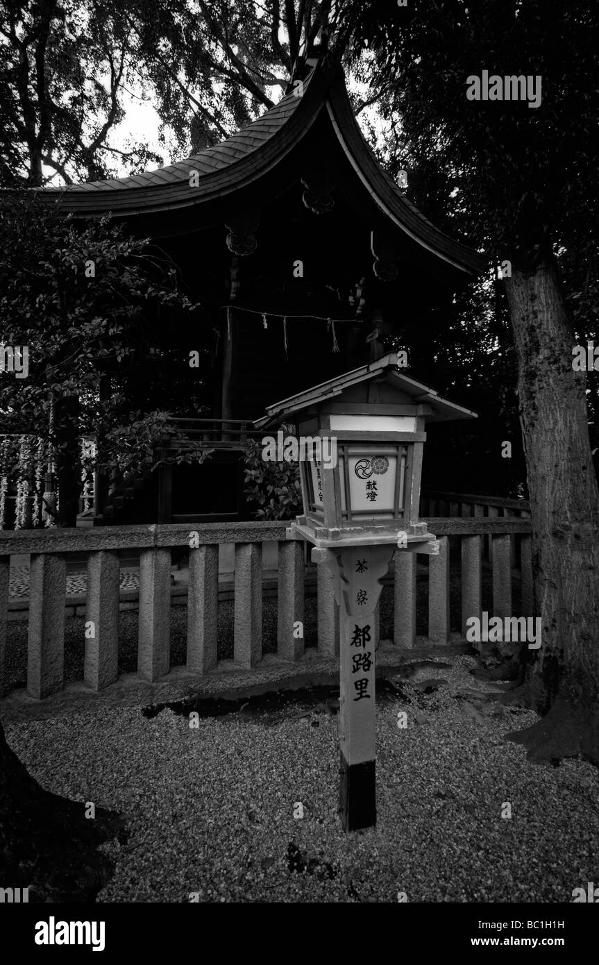 Japanese wooden lantern and little shrine. Yasaka Shinto Shrine complex (aka Yasaka-jinja or Gion Shrine). Kyoto. Kansai. Japan Stock Photo