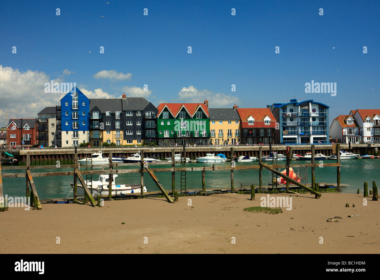 Colourful new apartments on the bank of the River Arun, Pier Road, Littlehampton, West Sussex, England, UK. Stock Photo