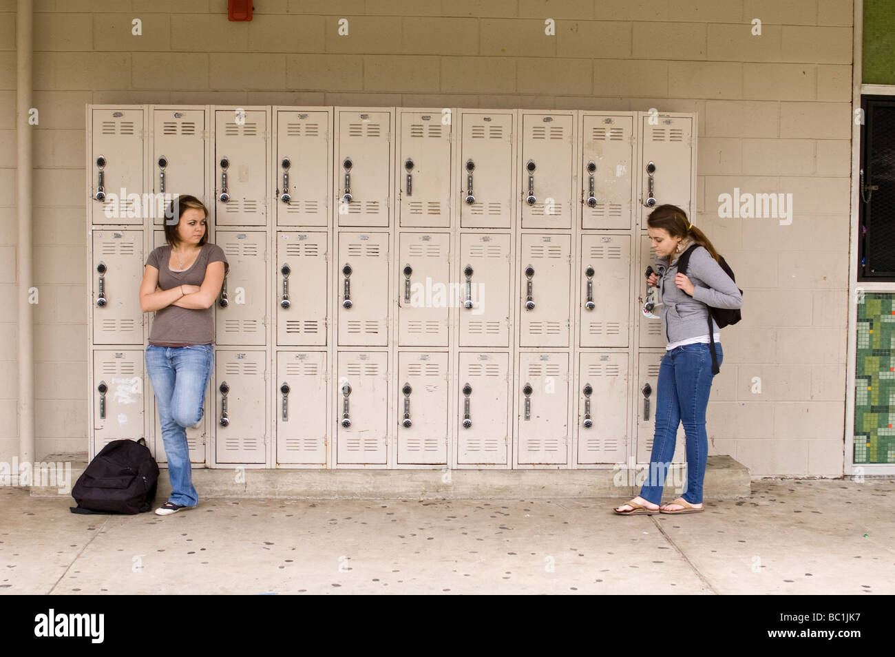 One twin girl angry at her sister in front of their lockers at El Modena High School in Orange, California Stock Photo