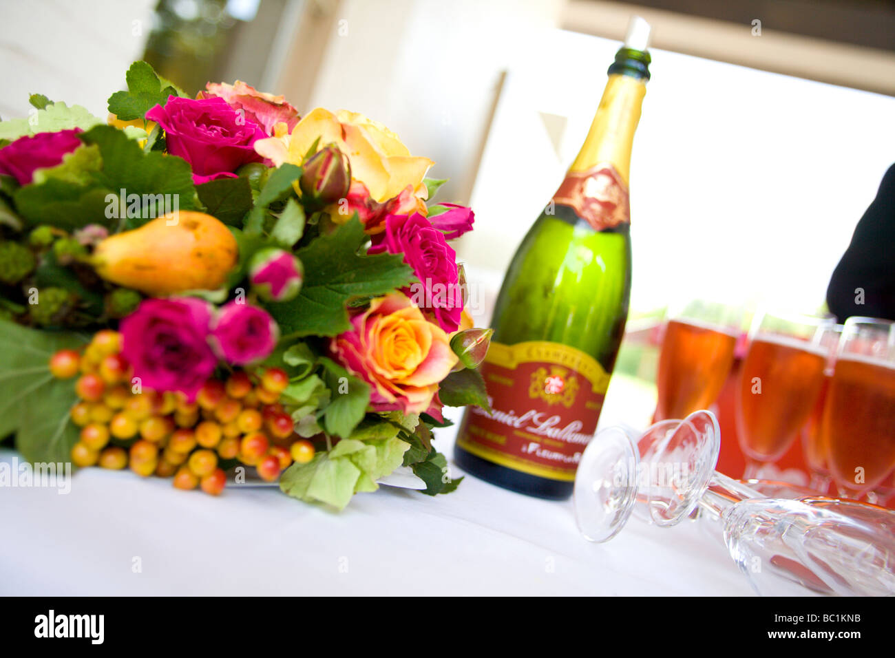 A wedding celebration showing a champagne bottle, champagne glasses