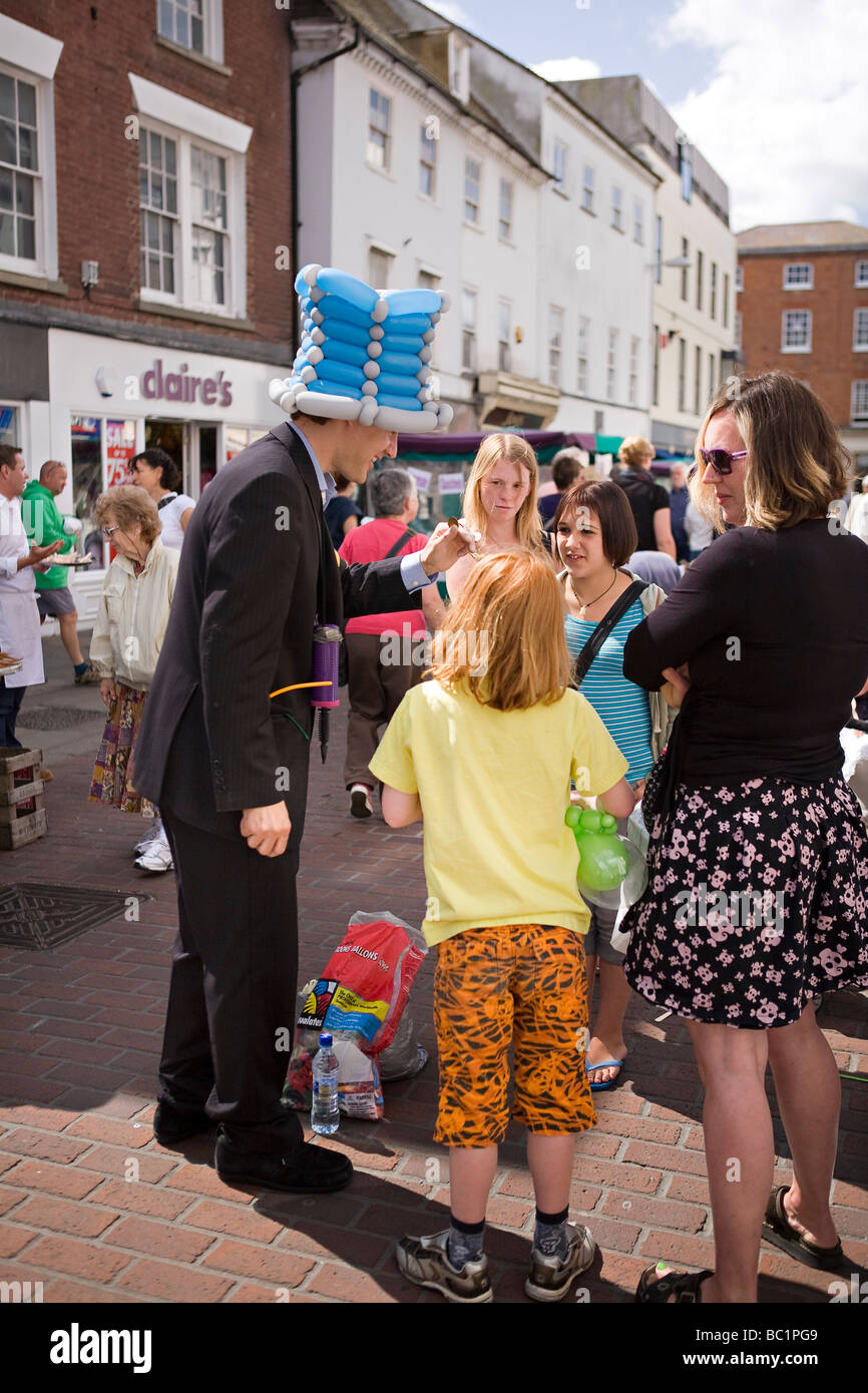 Street entertainer performing magic tricks for children in Chichester