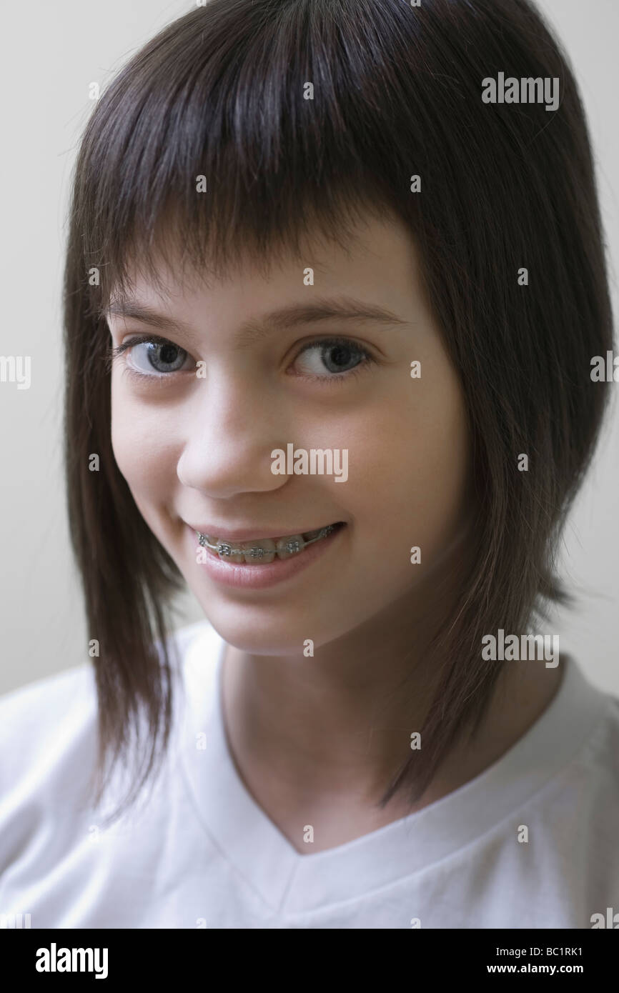 Studio portrait of girl with brown hair, smiling Stock Photo - Alamy