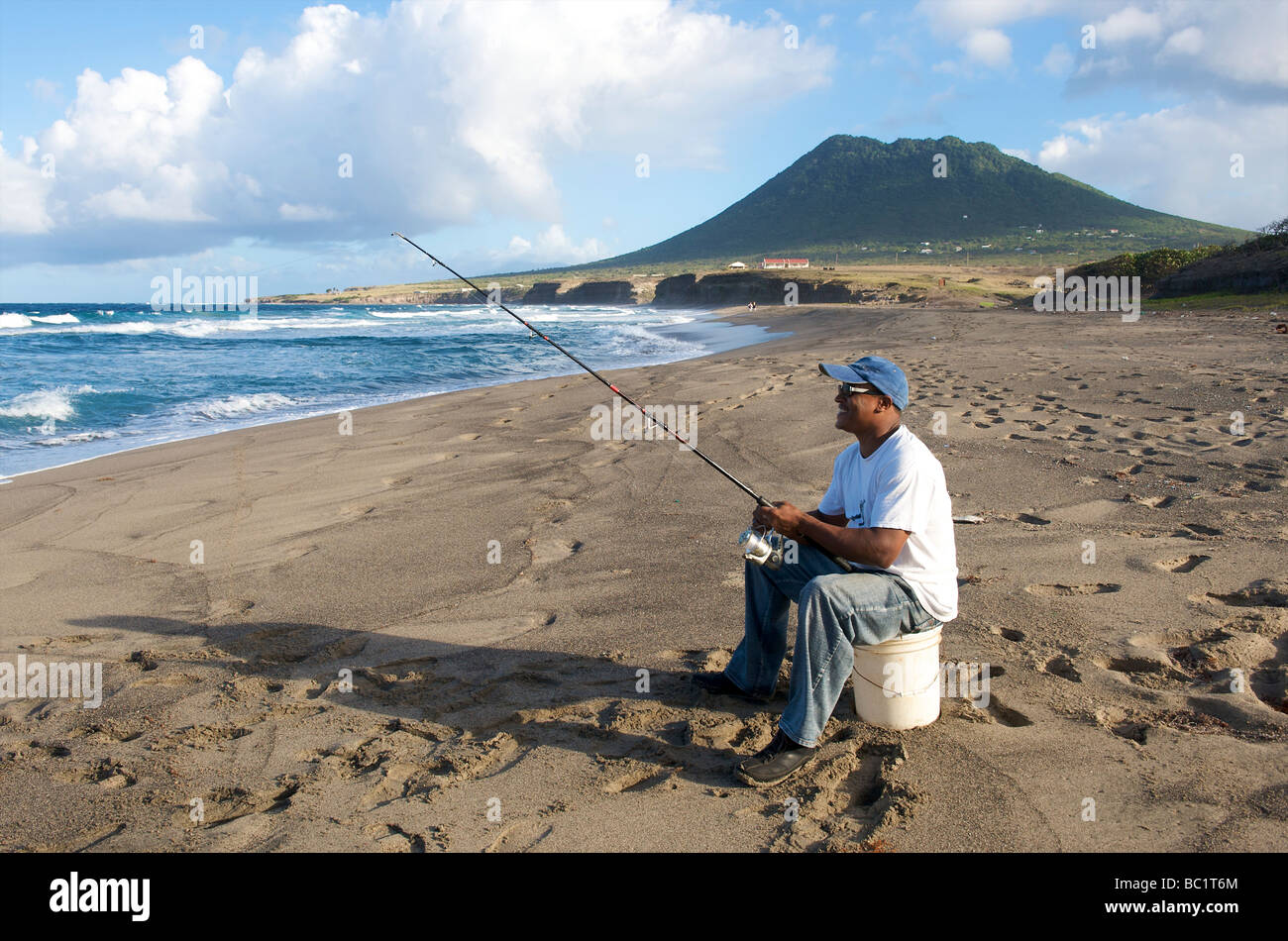 Man fishing off the beach hi-res stock photography and images - Alamy