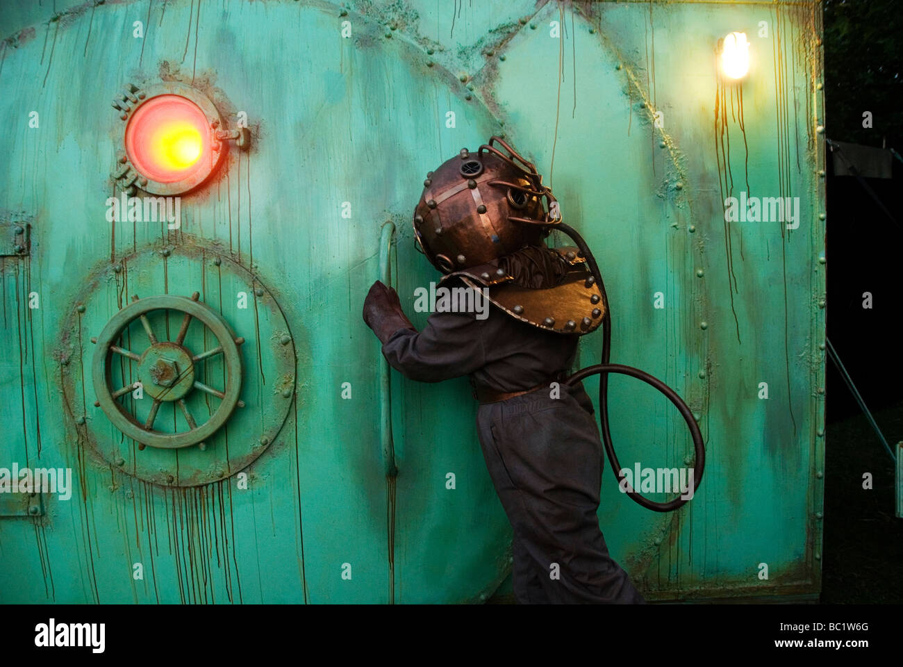 Actor dressed as deep sea diver opens the door to the Bar of Ideas Stock Photo