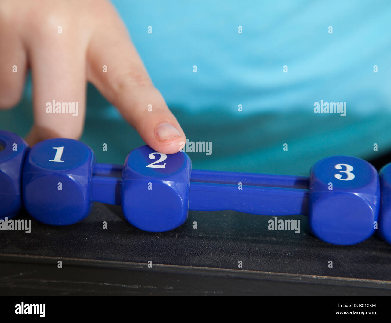 Child moving the number two as she keeps score Stock Photo