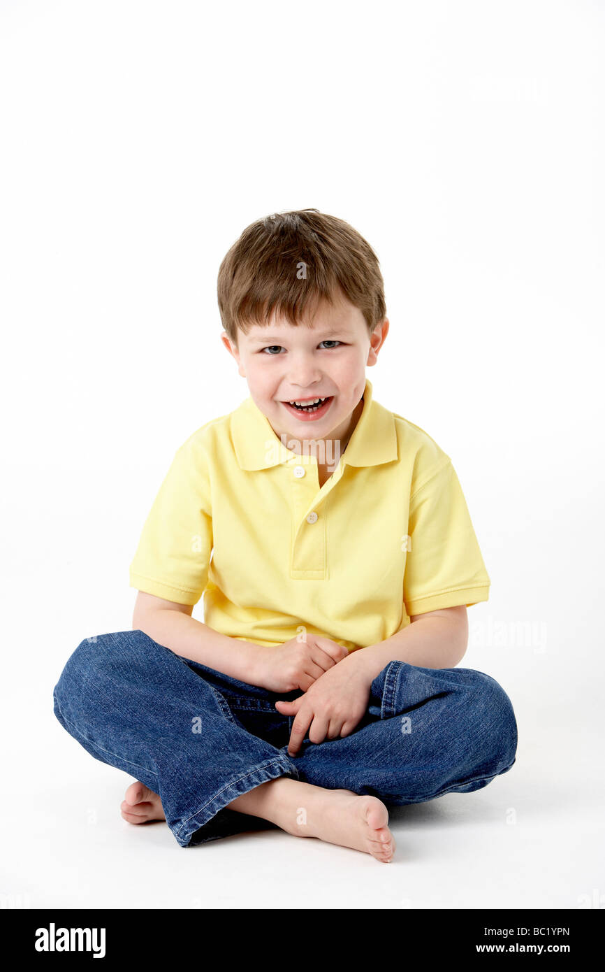 Young Boy Sitting In Studio Stock Photo - Alamy