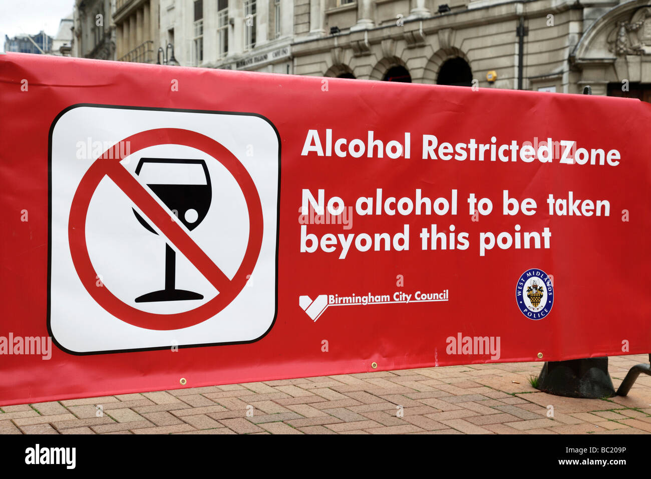 alcohol restricted zone banner stopping people from taking drinks from outside victoria square birmingham uk Stock Photo