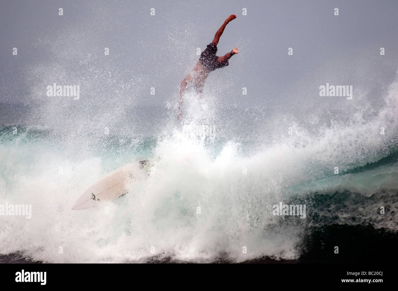 Surfer surfs wipe out, flys off of board ocean spray as wave breaks dramatic, arugam bay east coast Sri Lanka Stock Photo