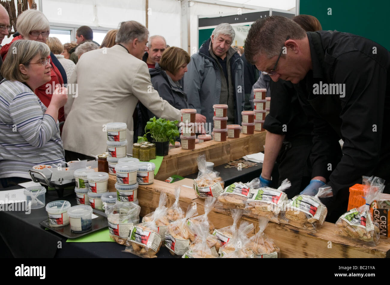 Crowds of people looking at displays of produce at a Food and Drinks