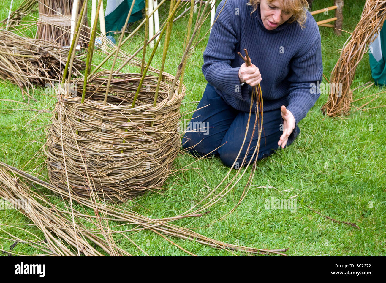 Woman  demonstrating basket weaving at  Bolsover castle Derbyshire  East Midlands England UK Stock Photo
